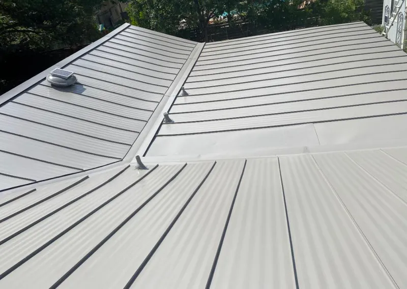 Solar attic fan installed on a metal roof for Roof Ventilation in East Grand Forks